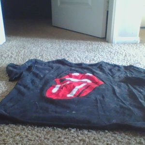 A T that is from the rolling stones. It is a large and it is black and red.